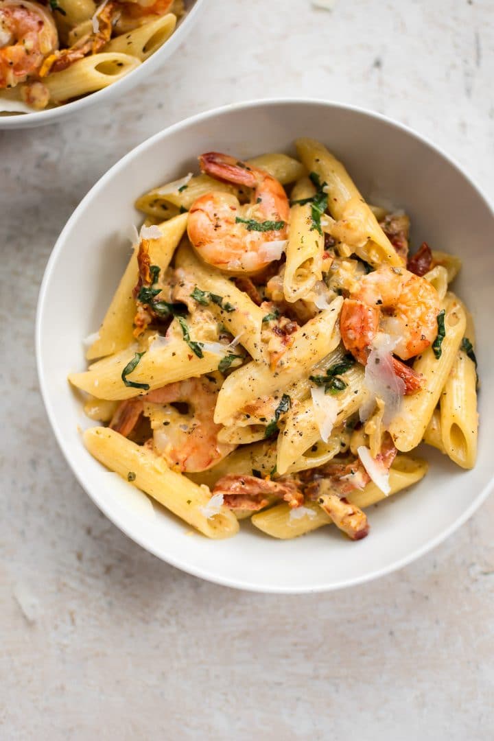 bowl of Cajun shrimp pasta with grated parmesan garnish