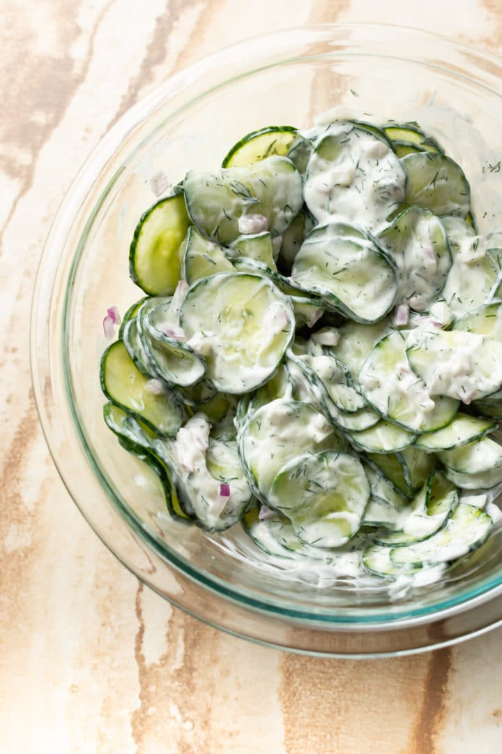 creamy cucumber salad in glass prep bowl