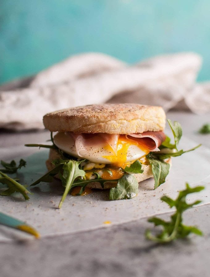 poached egg and prosciutto brunch sandwich with arugula