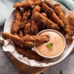 Crispy battered fried pickles with deliciously tangy remoulade sauce makes a fantastic appetizer!