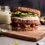 This Green Goddess chicken sandwich is a delicious way to use up leftover chicken (or leftover turkey!). Homemade Green Goddess dressing, smoky bacon, avocado, and crisp salad greens complete this tasty sandwich.