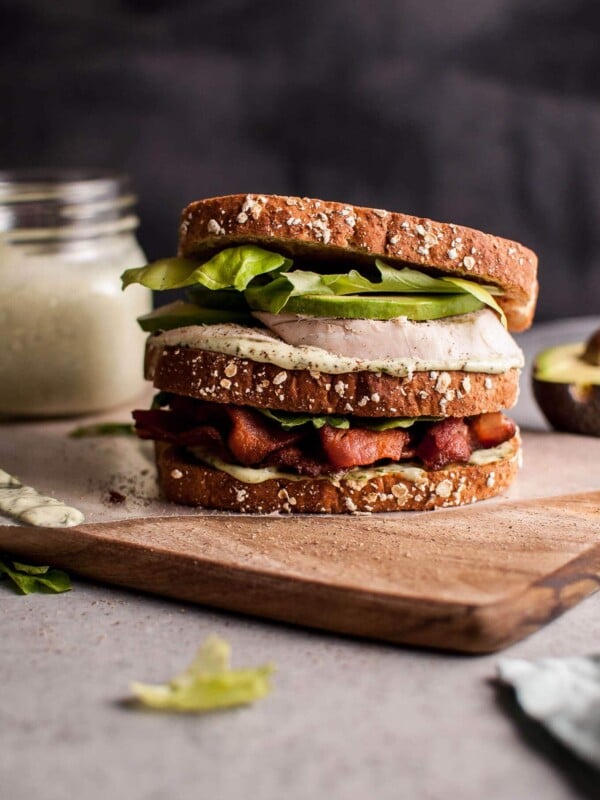 This Green Goddess chicken sandwich is a delicious way to use up leftover chicken (or leftover turkey!). Homemade Green Goddess dressing, smoky bacon, avocado, and crisp salad greens complete this tasty sandwich.