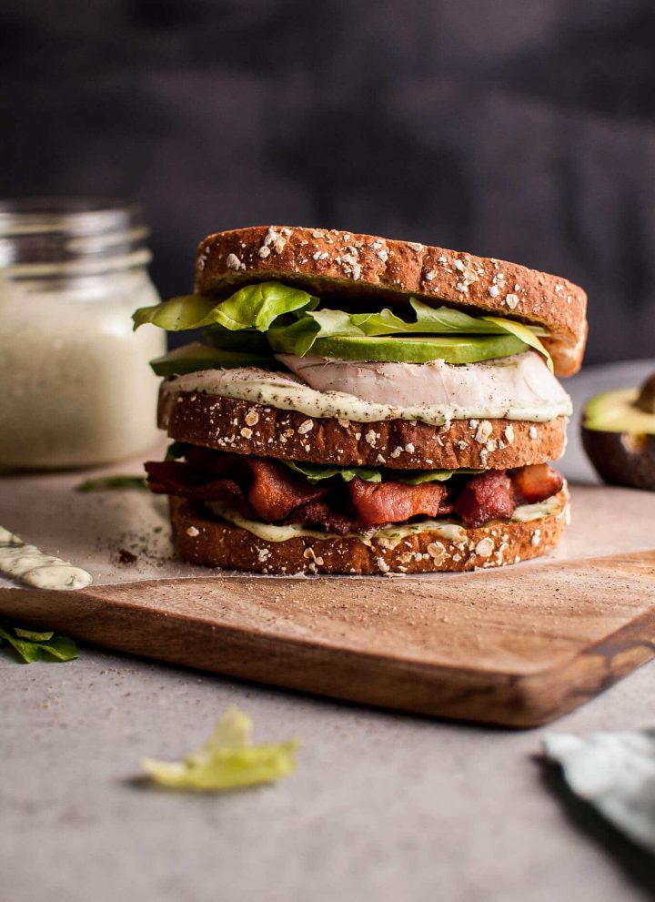 This Green Goddess chicken sandwich is a delicious way to use up leftover chicken (or leftover turkey!). Homemade Green Goddess dressing, smoky bacon, avocado, and crisp salad greens complete this tasty sandwich.
