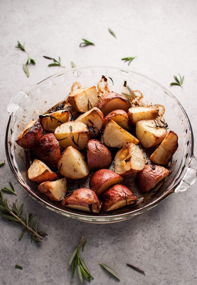 glass serving bowl with lemon and rosemary roasted potatoes