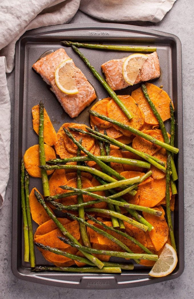 maple salmon with asparagus and sweet potatoes on a baking sheet