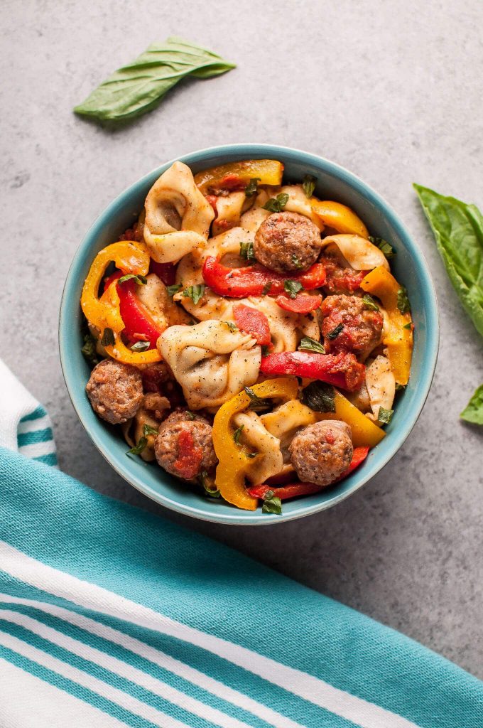 blue bowl with easy sausage tortellini with peppers