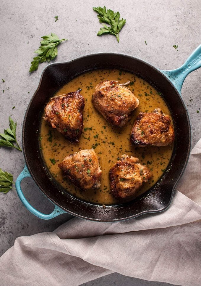 cast iron skillet with crispy honey Dijon chicken