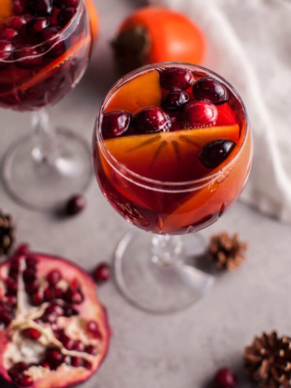 Pomegranate and persimmon winter sangria is a refreshing punch that is sure to be a big hit at your holiday party!