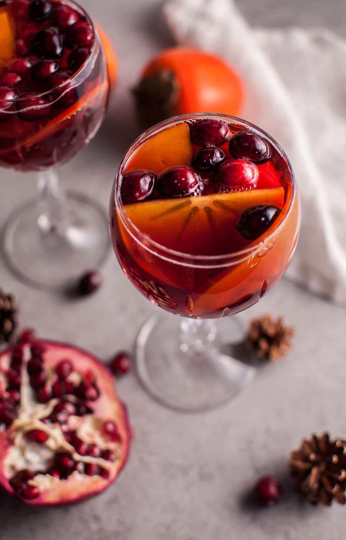 two glasses of pomegranate and persimmon winter sangria punch