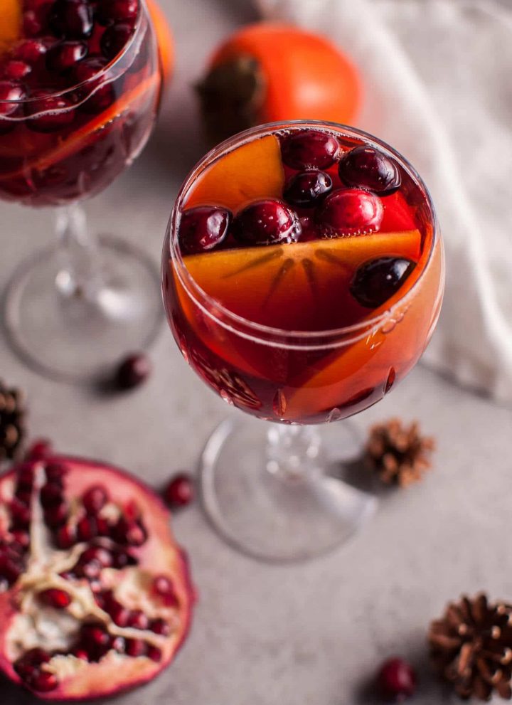 Pomegranate and persimmon winter sangria is a refreshing punch that is sure to be a big hit at your holiday party!