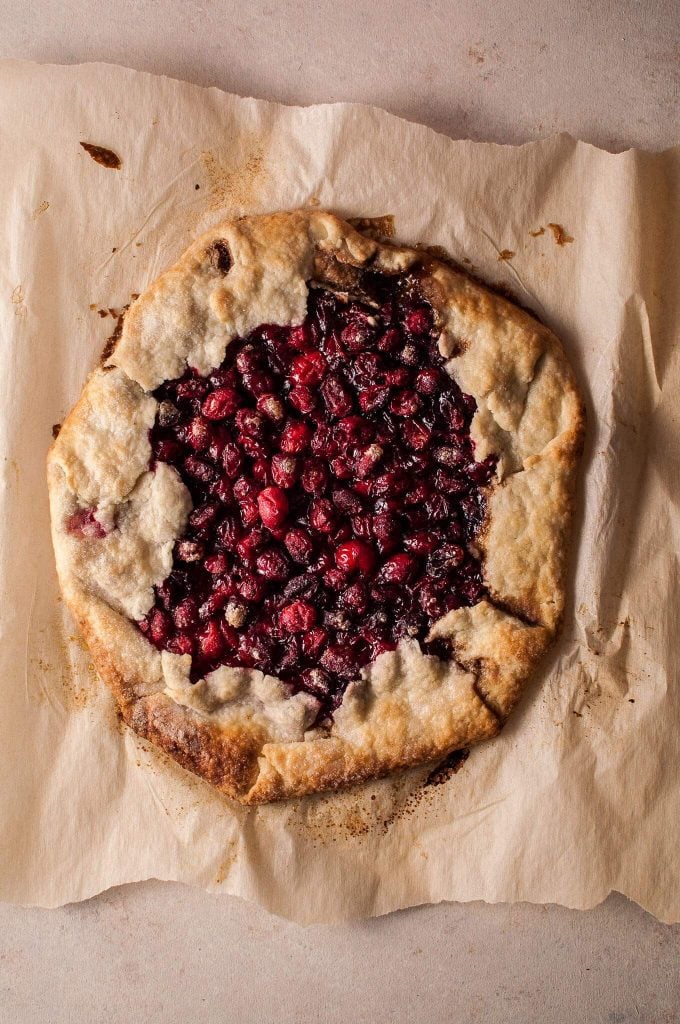 a whole festive cranberry galette on parchment paper