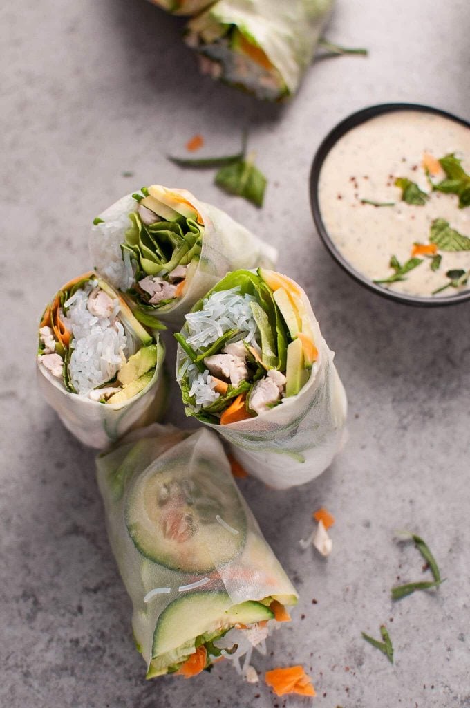 chicken salad rolls cut in half beside bowl of miso tarragon dipping sauce