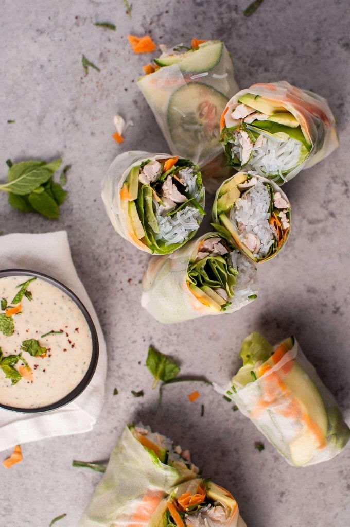 several chicken salad rolls with miso tarragon dipping sauce in a bowl