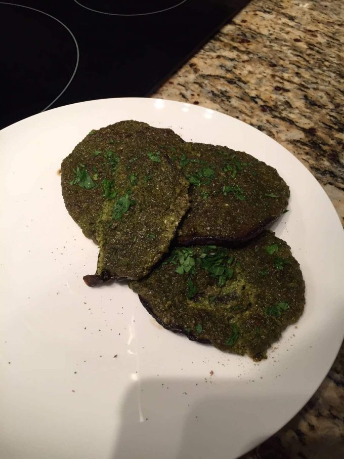 portobello mushrooms doused in pesto and parsley garnish but looking bad