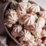 These red and green striped Christmas meringue cookies are light, melt-in-your-mouth, and fun. Flavored with vanilla and almond, and swirled with red and green, these sweet treats are extra festive.