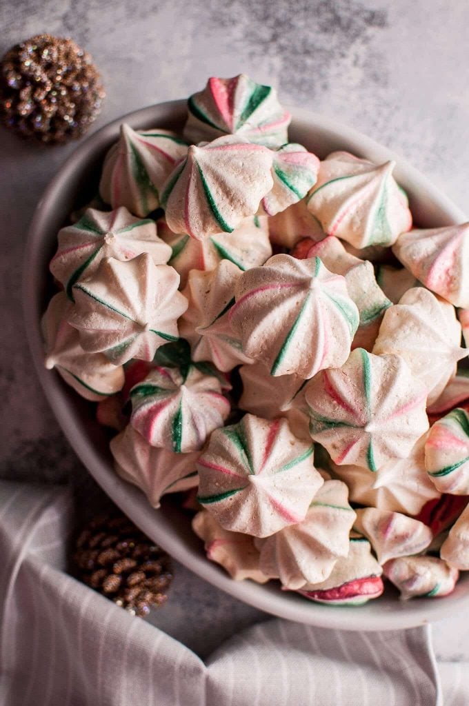 festive red and green striped Christmas meringue cookies in a bowl
