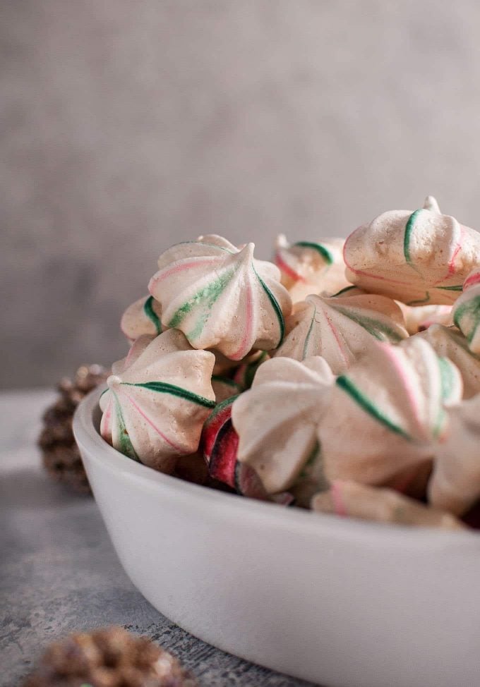 close-up of a bowl with red and green vanilla meringue cookies