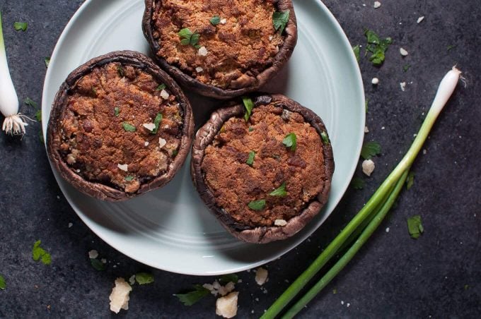 three portobello mushrooms on a plate with unappetizing filling