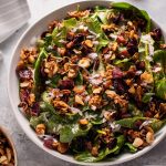 Spinach salad with crispy pancetta and candied nuts is a hearty winter salad that will satisfy your sweet and salty cravings.