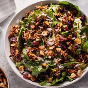 Spinach salad with crispy pancetta and candied nuts is a hearty winter salad that will satisfy your sweet and salty cravings.