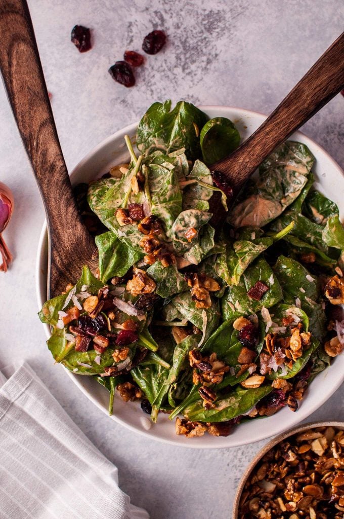 bowl of winter salad with spinach, pancetta, and candied nuts