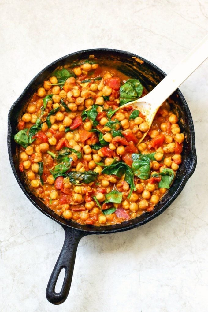 cast iron skillet with chickpea and spinach curry