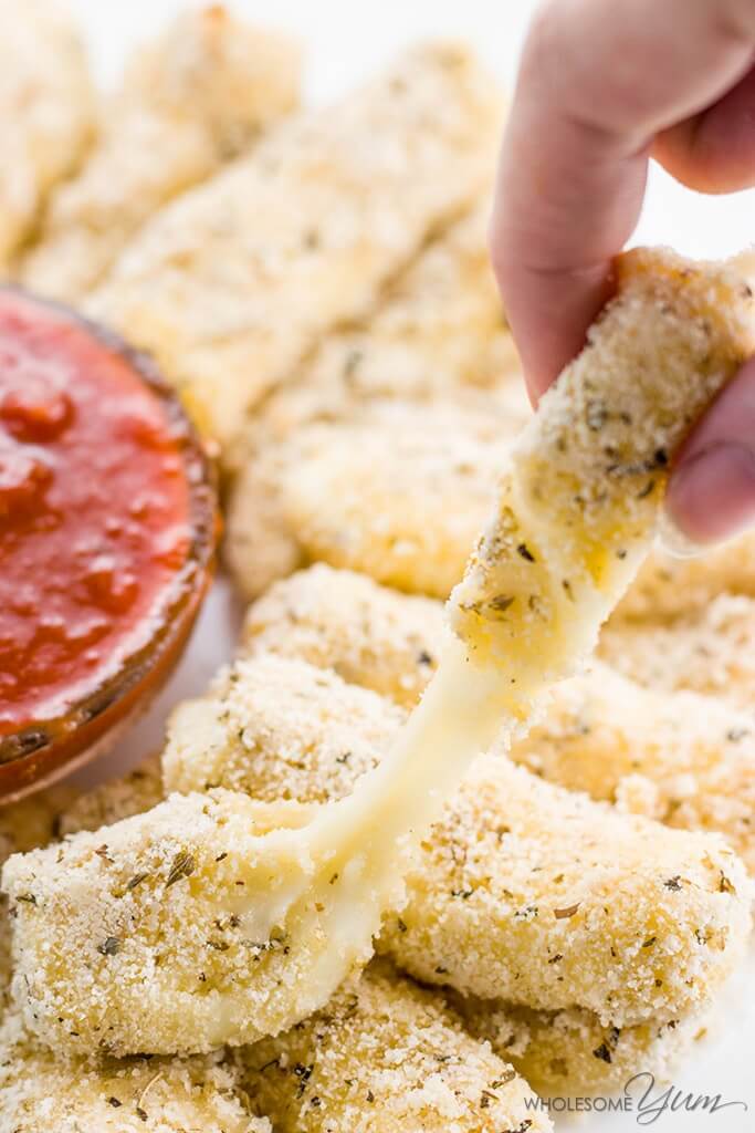 hand holding a low-carb cheese stick