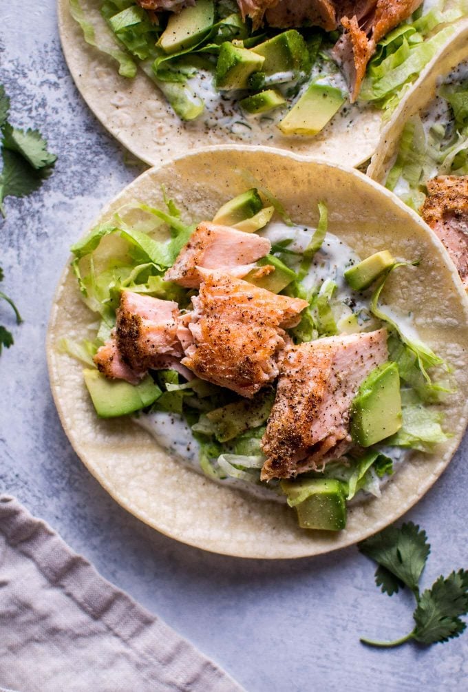 healthy baked salmon tacos with avocado and cilantro lime Greek yogurt dressing