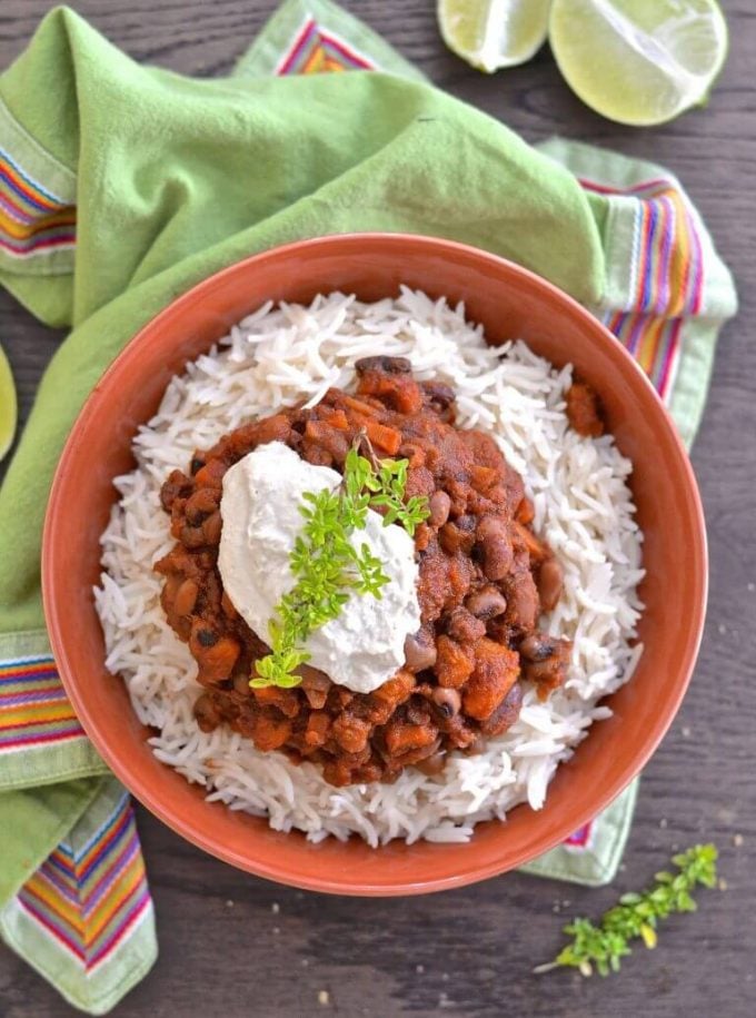 three bean sweet potato chili on rice in a bowl