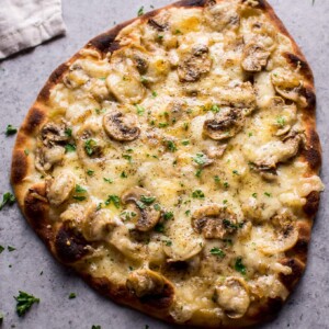 This vegetarian truffled mushroom naan pizza is super easy, a little fancy, and tastes way better than you'd expect from a quick homemade pizza!