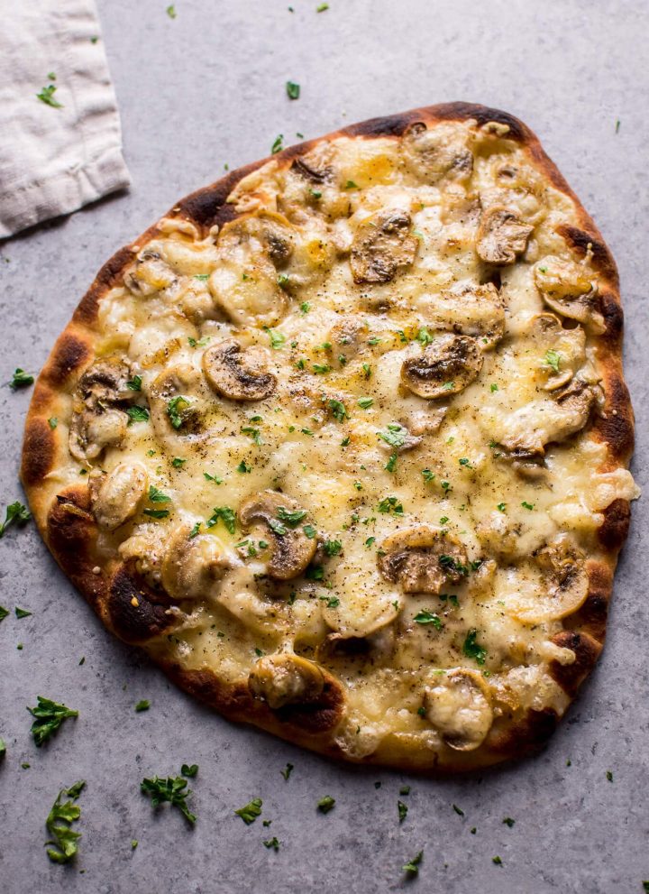 This vegetarian truffled mushroom naan pizza is super easy, a little fancy, and tastes way better than you'd expect from a quick homemade pizza!