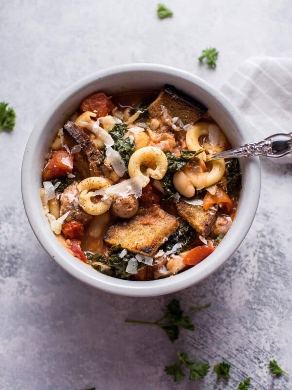 This Tuscan chicken sausage soup with white beans and pasta is healthy, hearty, and full of flavor! Optional garlic croutons and parmesan shavings make it extra delicious.