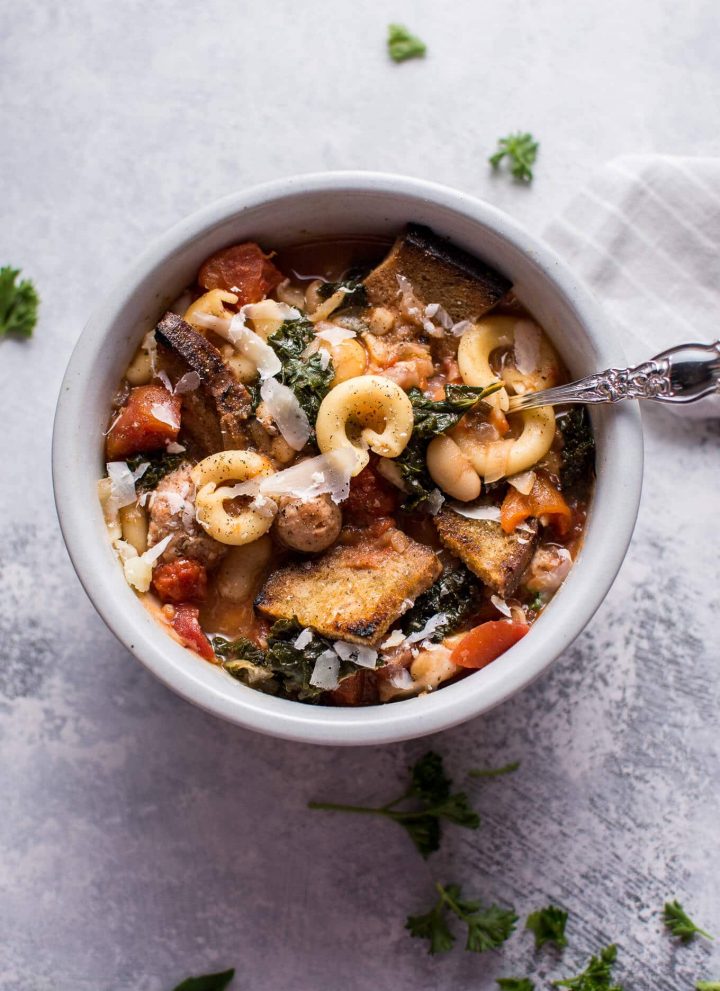 This Tuscan chicken sausage soup with white beans and pasta is healthy, hearty, and full of flavor! Optional garlic croutons and parmesan shavings make it extra delicious.