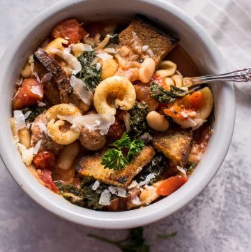 This Tuscan chicken sausage soup with white beans and pasta is healthy, hearty, and full of flavor! Optional garlic croutons and parmesan shavings make it extra delicious.