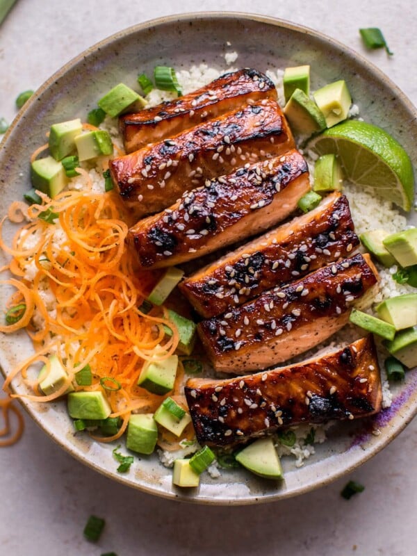 This glazed hoisin and sesame salmon bowl is a delicious low-carb meal idea, served on a bed of cauliflower rice.