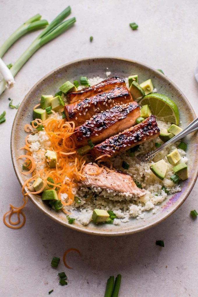 low-carb hoisin salmon bowl with avocado, cauliflower rice, and a fork