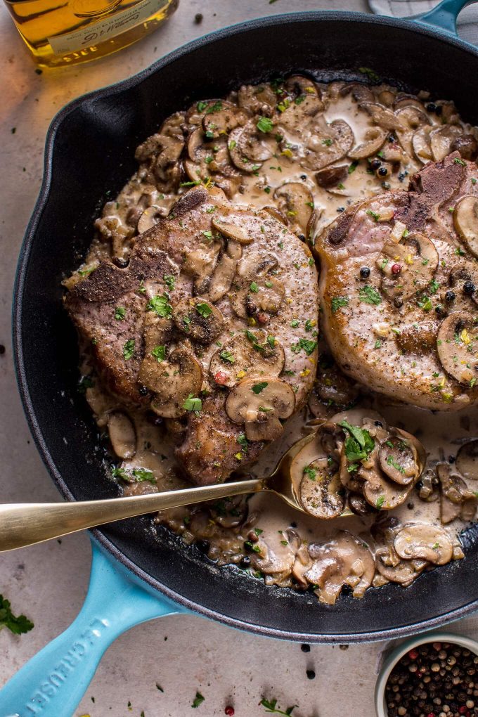 close-up of pork chops with an Irish whiskey cream sauce and a serving spoon
