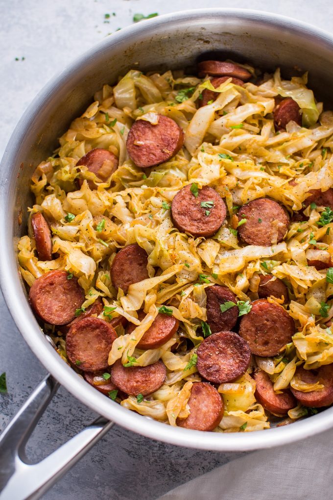 metal skillet with sauteed cabbage and kielbasa