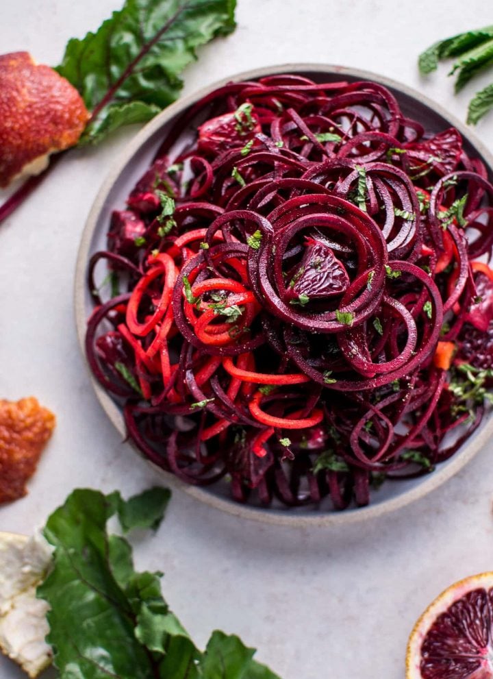 bowl of spiralized raw beet salad with blood oranges