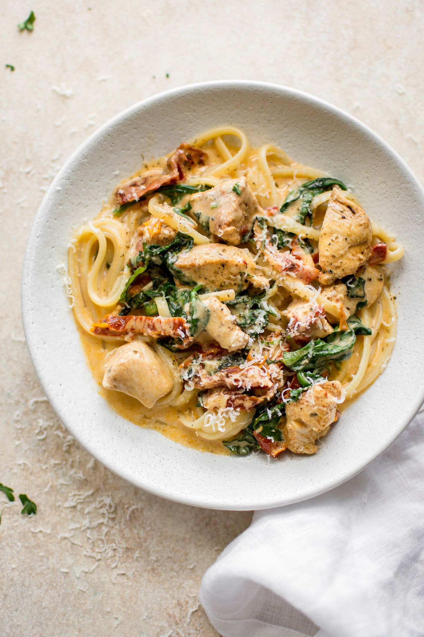 This creamy Tuscan chicken pasta recipe is even better than the Olive Garden's! You can quickly make this easy chicken, spinach, and sun-dried tomato pasta with a creamy garlic sauce at home in under half an hour!