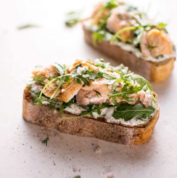 Baked salmon, lemon, crusty bread, fresh dill, Greek yogurt, shallot, and arugula make this salmon tartine one delicious open-faced sandwich! Ready in 20 minutes.