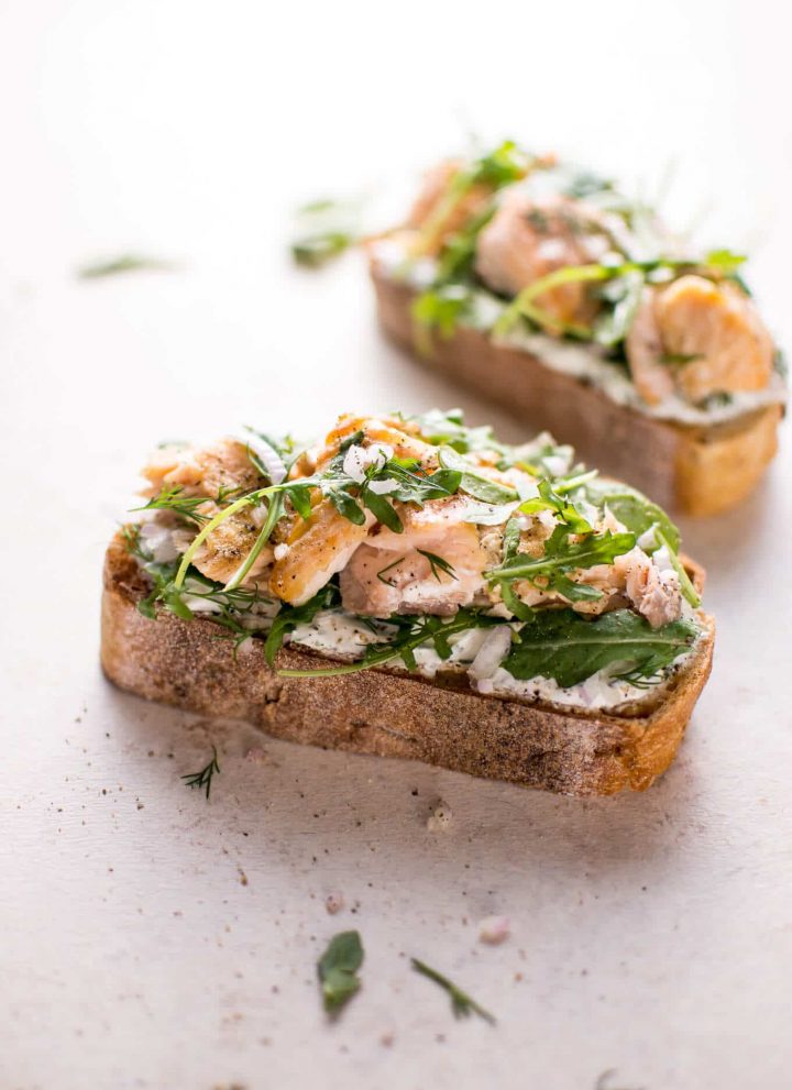 Baked salmon, lemon, crusty bread, fresh dill, Greek yogurt, shallot, and arugula make this salmon tartine one delicious open-faced sandwich! Ready in 20 minutes.