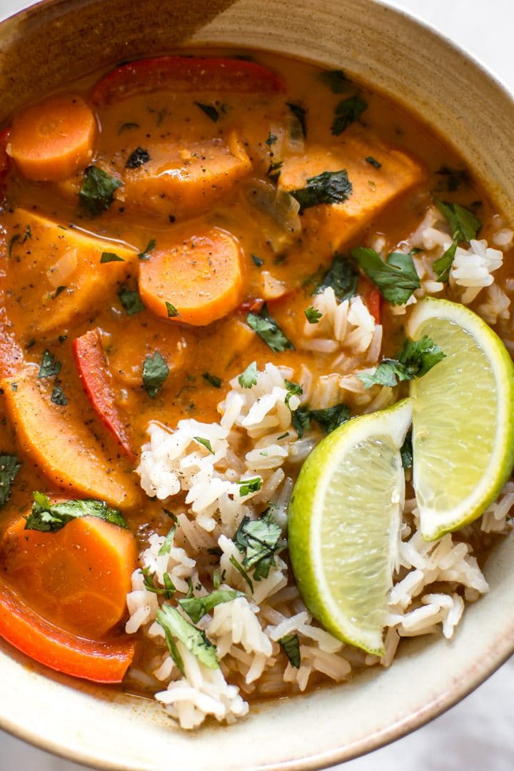 close-up of thai vegan coconut curry in a bowl garnished with lime