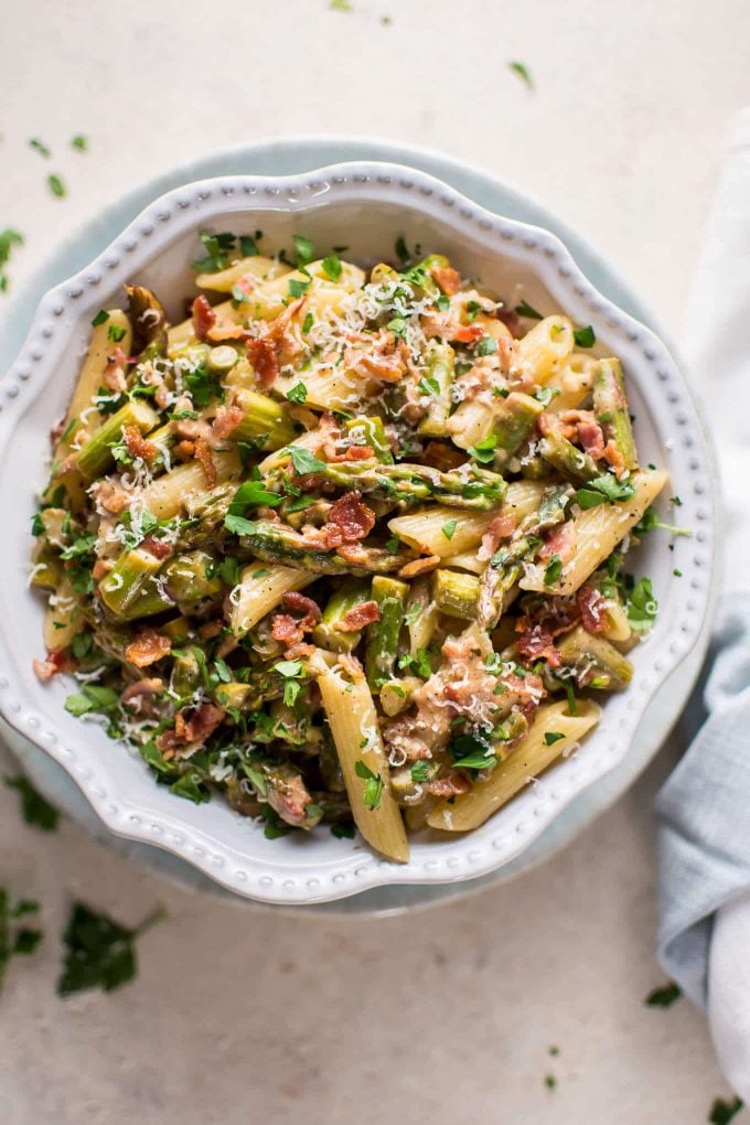 white bowl with lemon asparagus and bacon pasta