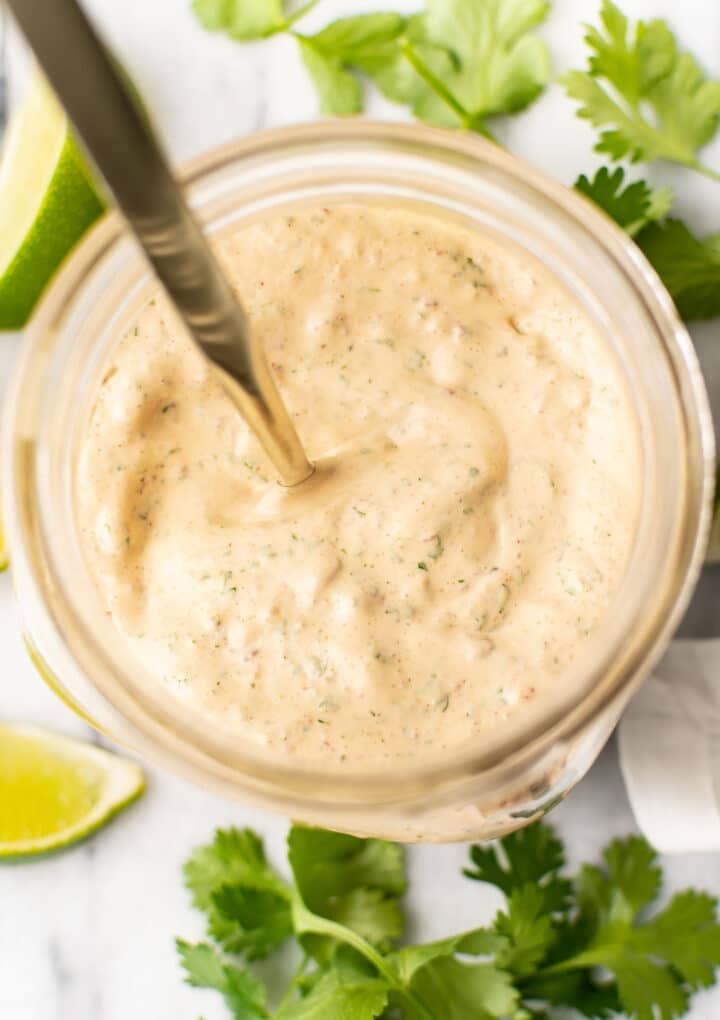 a jar with a spoon and homemade chipotle ranch dressing