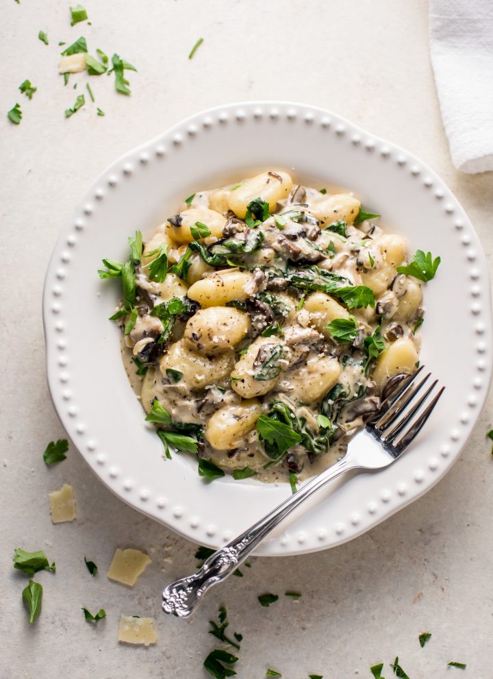 This creamy mushroom and spinach gnocchi is a restaurant-worthy dinner made in one pan and ready in less than 30 minutes!