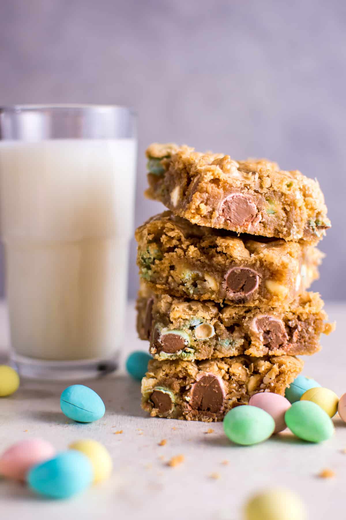 mini egg cookie bars with a glass of milk