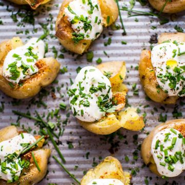 These garlic and lemon smashed potatoes are a fresh and flavorful side dish or party finger food. Replacing sour cream with Greek yogurt also makes these healthier!