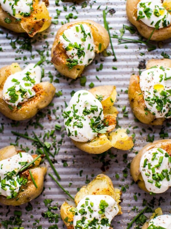 These garlic and lemon smashed potatoes are a fresh and flavorful side dish or party finger food. Replacing sour cream with Greek yogurt also makes these healthier!