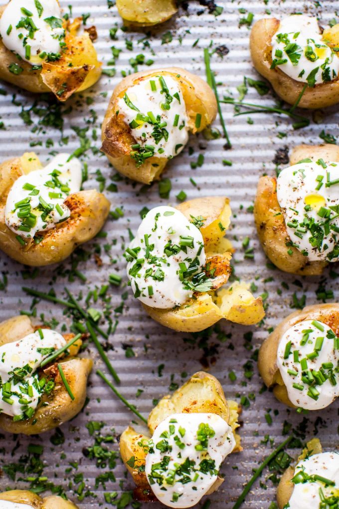 close-up of garlic and lemon smashed potatoes on a baking sheet